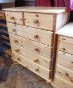 Modern pine chest of two short and three long drawers with turned knob handles