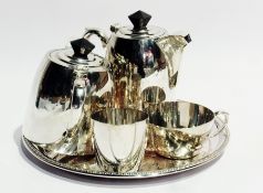 A silver plate circular presentation tray and a four piece teaset comprising teapot, hot water