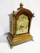 Late 19th century German mantel clock in a domed oak case with ormulu mounts, brass style and silver