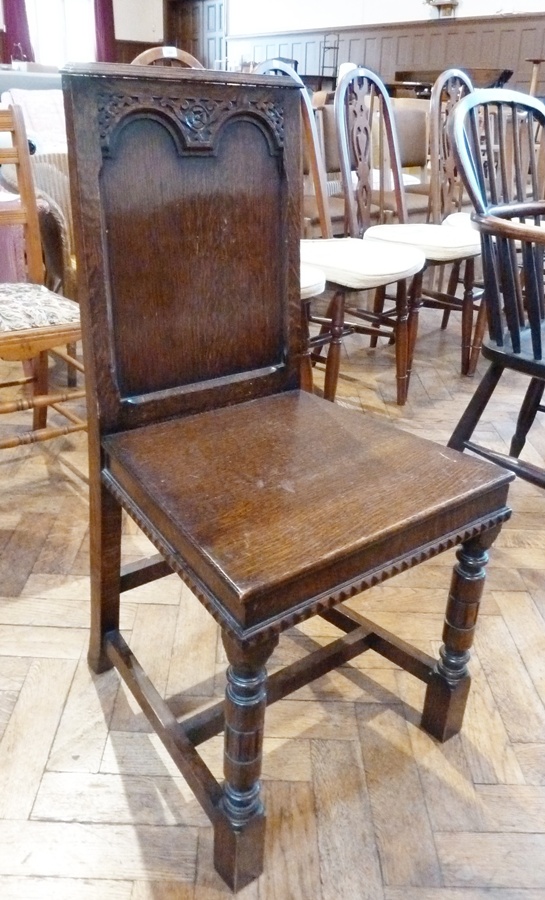 Oak hall chair, the rectangular back with stepped pediment, scroll carved double arched framed panel