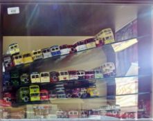Collection of EFE 1:76 scale diecast buses and coaches in a glazed display case