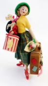 Spanish felt doll, in 1950's style dress, with painted face, carrying dog and luggage, height 27cm
