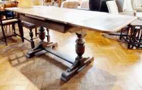 Oak draw-leaf dining table on large bulbous cup and cover type support, sledge feet
