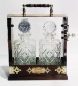 A twin decanter tantalus, the square cut glass decanters with faceted knob stoppers, the locking