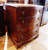 Mahogany-effect serpentine-fronted chest of four long drawers with ring handles on bracket feet,