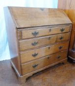 Antique oak bureau, the sloping fall front enclosing fitted interior having four long drawers with