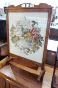 Stained wood and woolwork tapestry firescreen with pierced handle to the top, frame panel inset with