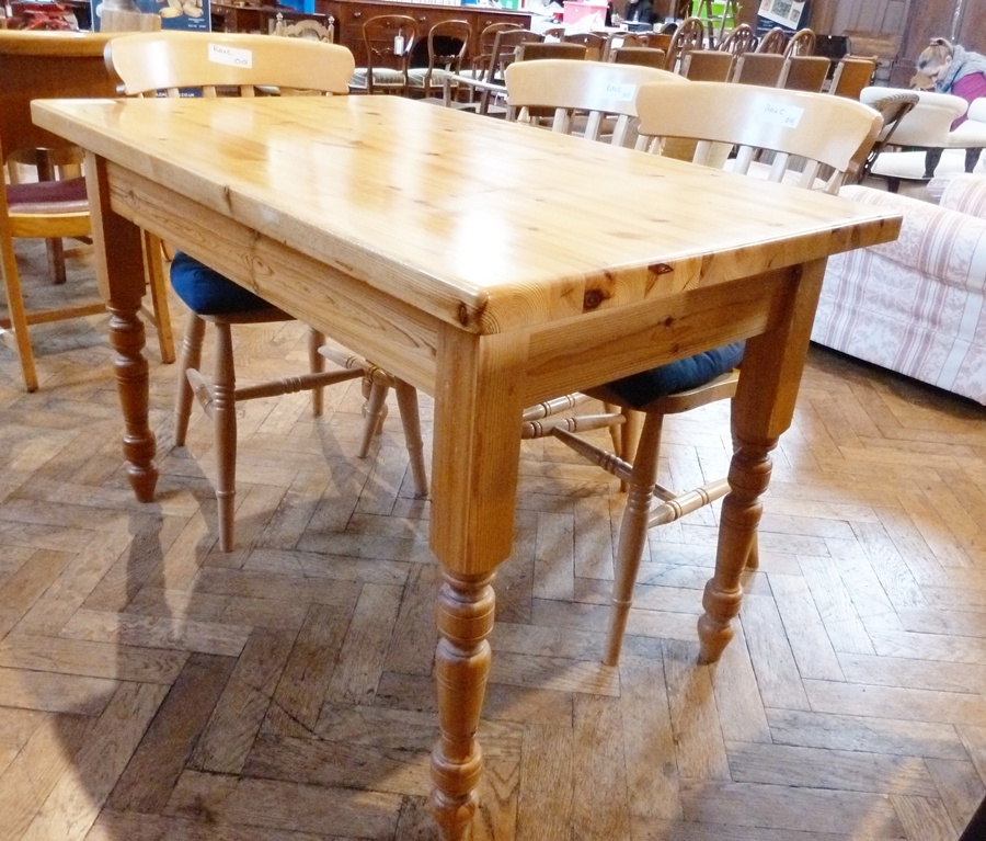 Modern pine dining table on turned supports and three modern lightwood kitchen dining chairs with