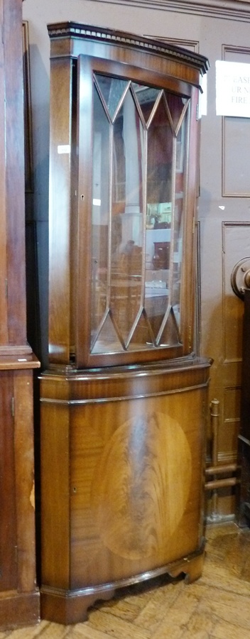 Reproduction mahogany floor-standing corner cabinet with glazed top section, enclosed cupboard below