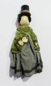 Painted wooden peg doll, with top hat and ribbons, green velvet jacket to dress, 36cm long