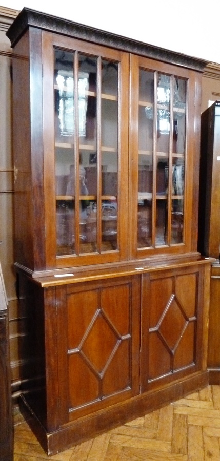 Stained wood mahogany bureau bookcase, the top with foliate carved cavetto cornice, three shelves
