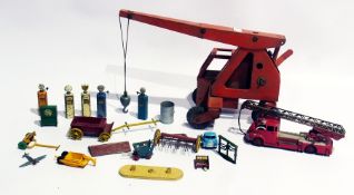 A Triang tinplate mobile crane, a Dinky Supertoys turntable fire escape, diecast petrol pumps,