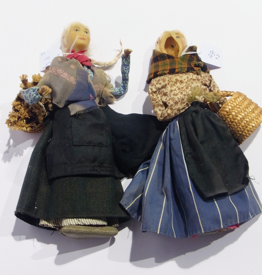 Two wax stick dolls, of flower girls, with painted faces, 29cm high (af)