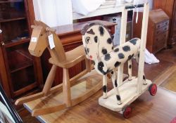 Child's wooden rocking horse, a wooden pull-along horse and a large toy train (3)