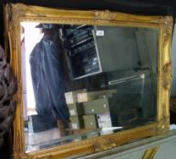 A rectangular wall mirror in a moulded gilt frame, with bevelled plate, width 88cms, together with