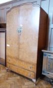 Mid 20th century figured walnut small wardrobe with arched top, shelves to the interior enclosed