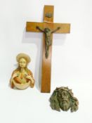 A wooden crucifix Our Saviour on the Cross, a bronzed metal bust of Jesus after Crucifixion and a