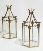 A pair of decorative brass ceiling lights with hexagonal engraved raised panels, height 35cms