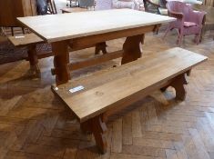 Pine refectory style dining table and two matching benches all with shaped end supports and cross