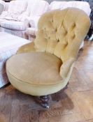 Victorian nursing chair with raised button back in gold dralon on turned supports, brass and ceramic