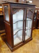 Stained mahogany effect display cabinet having blind fret frieze with two serpentine-shaped shells