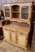 Modern beech dresser, the back with a pair of glazed cupboards and central shelves, three frieze