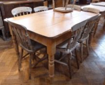 An old pine rectangular top kitchen table with turned legs, length 153cms, together with eight