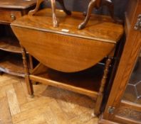 Oak oval top drop leaf tea trolley, with frieze drawer, and undershelf  on bobbin turned supports