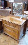 A reproduction oak chest of two short and two long drawers raised on bracket feet with mirror