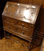 A reproduction oak glazed bureau bookcase, the upper section with pair of glazed doors, and a mirror