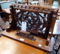 A 20th century oak wall shelf, with carved and pierced panelled back, 57 cm wide