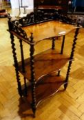 A Victorian rosewood three tier whatnot with foliate pierced gallery and three serpentine front