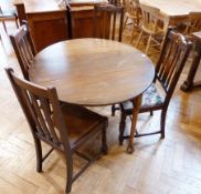 A Georgian style oak oval top drop leaf breakfast table, on turned tapering legs with pad feet,