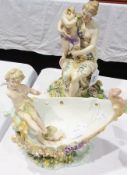Meissen style figure of mother and child, classical figure seated with cherubesque figure on her