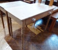 A Victorian rectangular top pine side table with a long frieze drawer, and china knob handles, on
