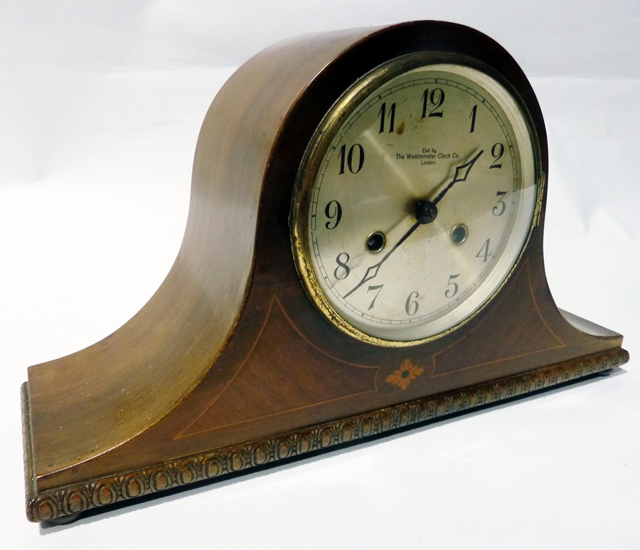 Polished wood Westminster Clock Company mantle clock in Napoleon's hat shaped case with stringing