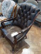 A Victorian mahogany gentleman's armchair, with leather studded upholstery, and padding to armrests,