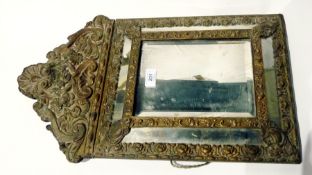 Embossed brass mounted 18th century style mirror with raised scroll and floral pediment