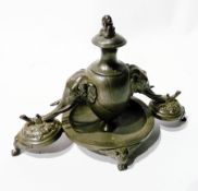 19th century pewter or Britannia metal inkstand, the ovoid inkwell with  pair elephant mask supports