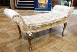 An upholstered two seater scroll end stool with button cushion seat, on cabriole legs with pad feet,