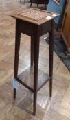 20th century oak jardiniere stand, with inset square tiled top, on tapered supports and second tier,