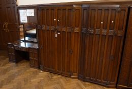 An early 20th century oak bedroom suite, comprising:- double wardrobe. single wardrobe and mirror-