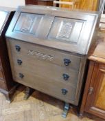 A modern stained oak bureau, with fitted interior, three long drawers raised on trestle supports,