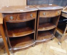 A pair of reproduction mahogany bow front cupboards, with frieze drawers, and open shelves, raised