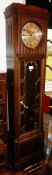 An Edwardian long case clock with hinged panel front and astragal glazed door revealing pendulum,