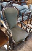 Victorian oak carved open armchair, with foliate carved toprail, green upholstered back and seat, on