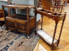 A modern oak two-tier trolley, with panelled cupboards below on castors and an oak umbrella stand (