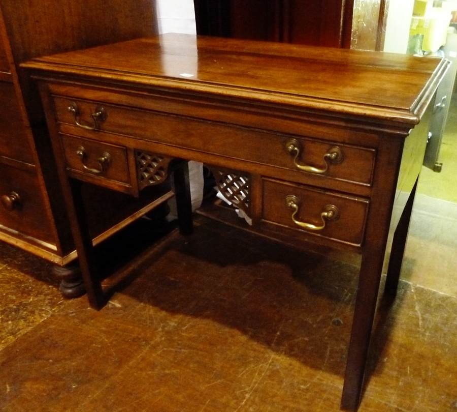 A Georgian mahogany lowboy with moulded edge top, long frieze drawer, with two short drawers and