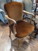A walnut open armchair, with brown upholstered back and seat, on cabriole supports