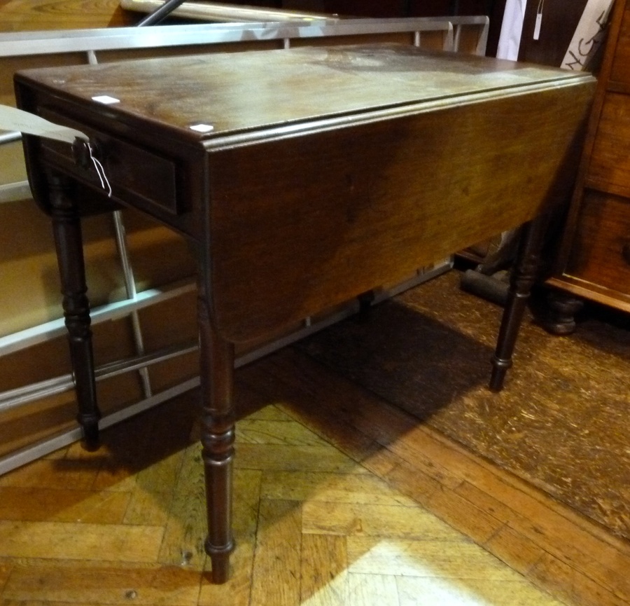 A Victorian mahogany drop flap Pembroke table, with frieze drawer on ringed turned tapering legs,